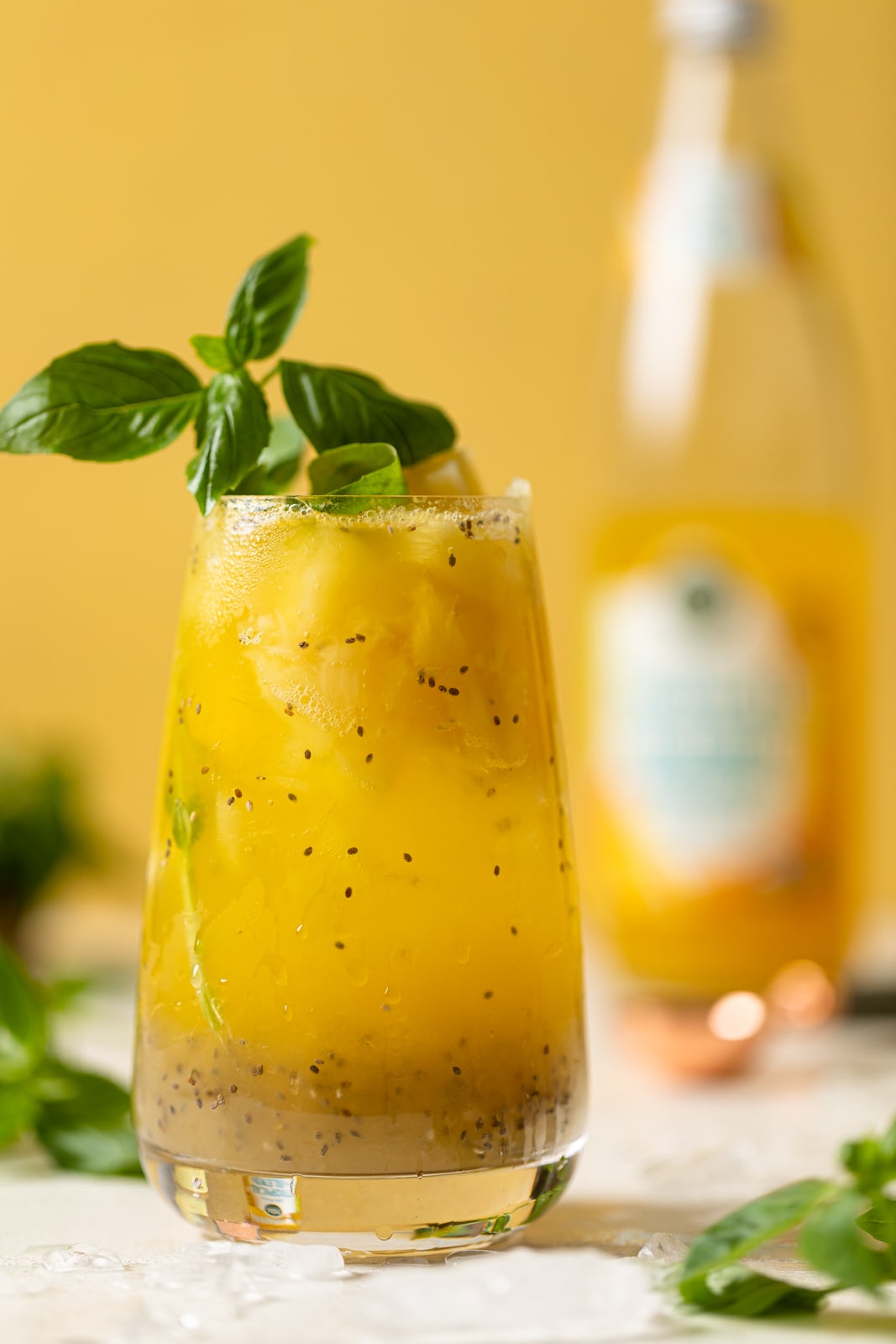 Closeup of a glass of bright yellow Pineapple Chia Seed Tropical Mocktail