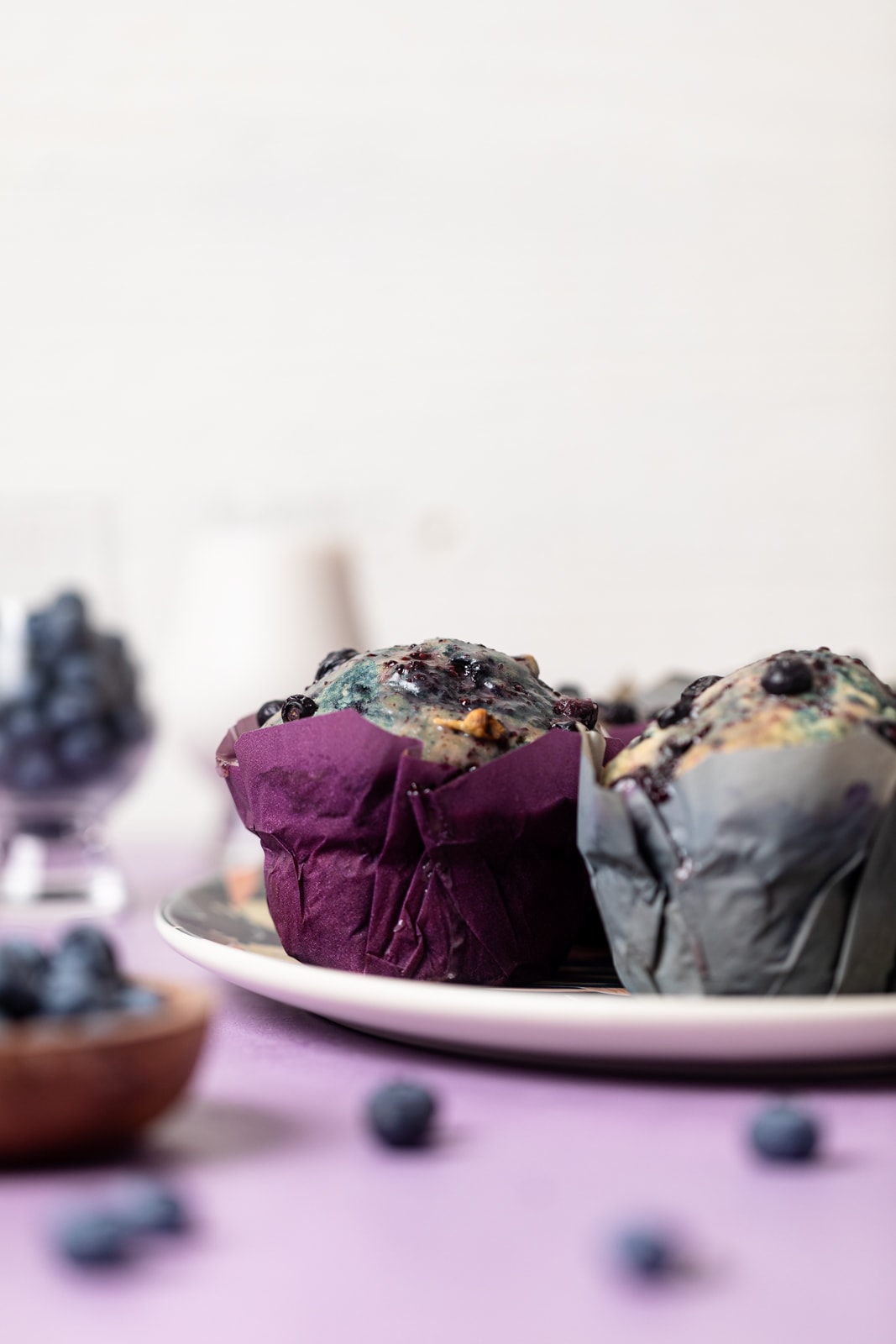 Side view of Vegan Roasted Blueberry Muffins on a plate