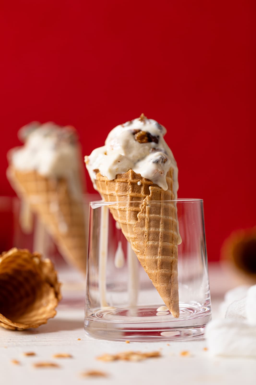 Closeup of two Maple Brown Butter Walnut Ice Creams in cones standing in glasses