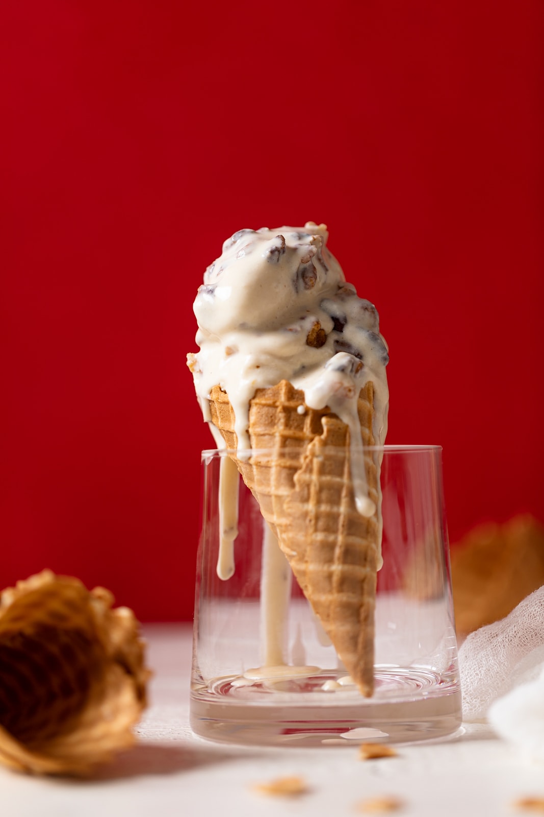 Maple Brown Butter Walnut Ice Cream melting down a cone standing in a glass