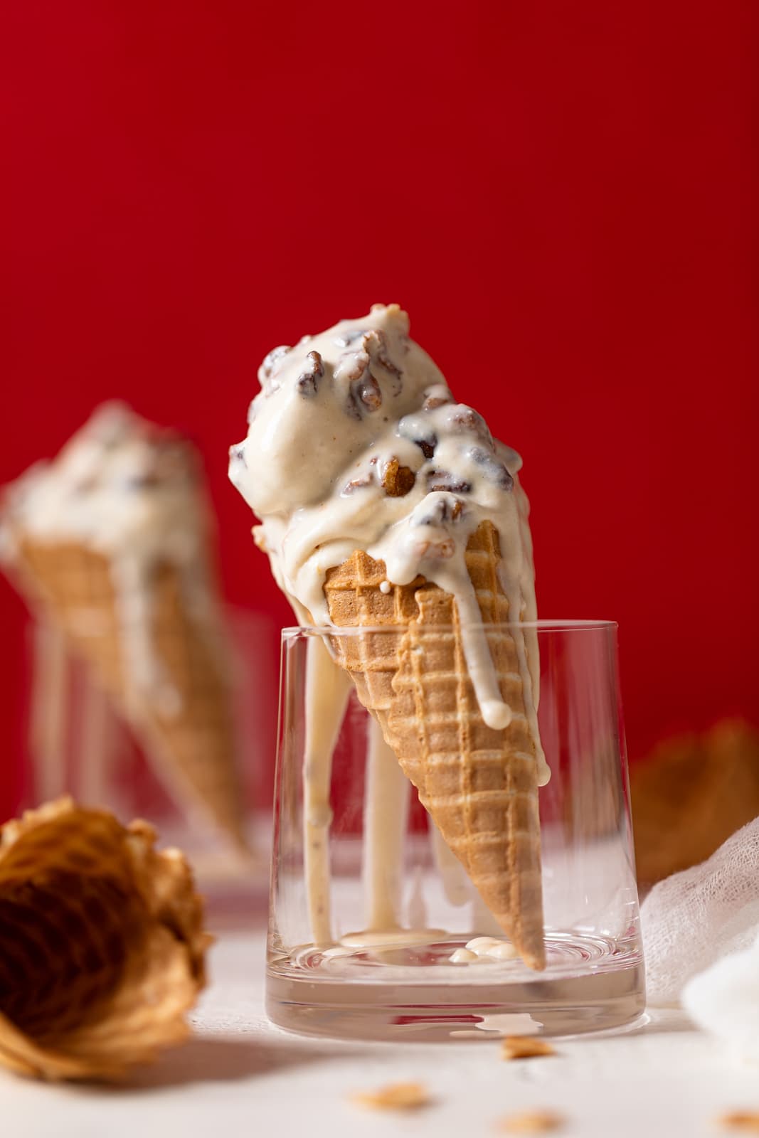 Maple Brown Butter Walnut Ice Cream melting down a cone standing in a glass