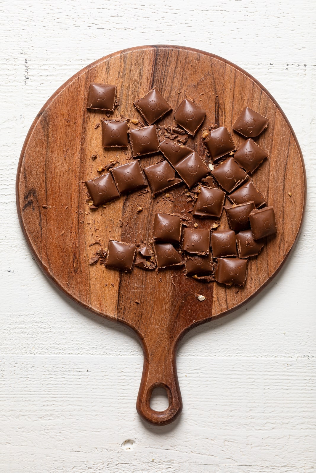 Chocolate pieces on a wooden cutting board