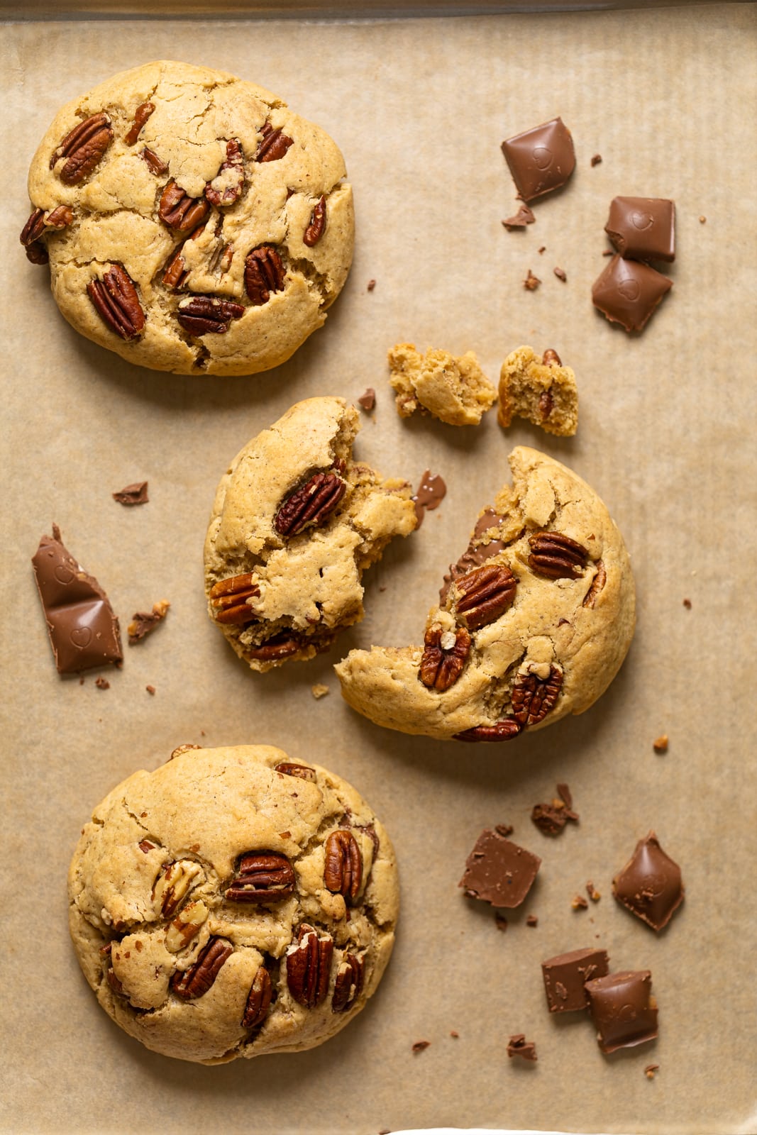 Broken Chocolate Stuffed Butter Pecan Cookie on parchment paper