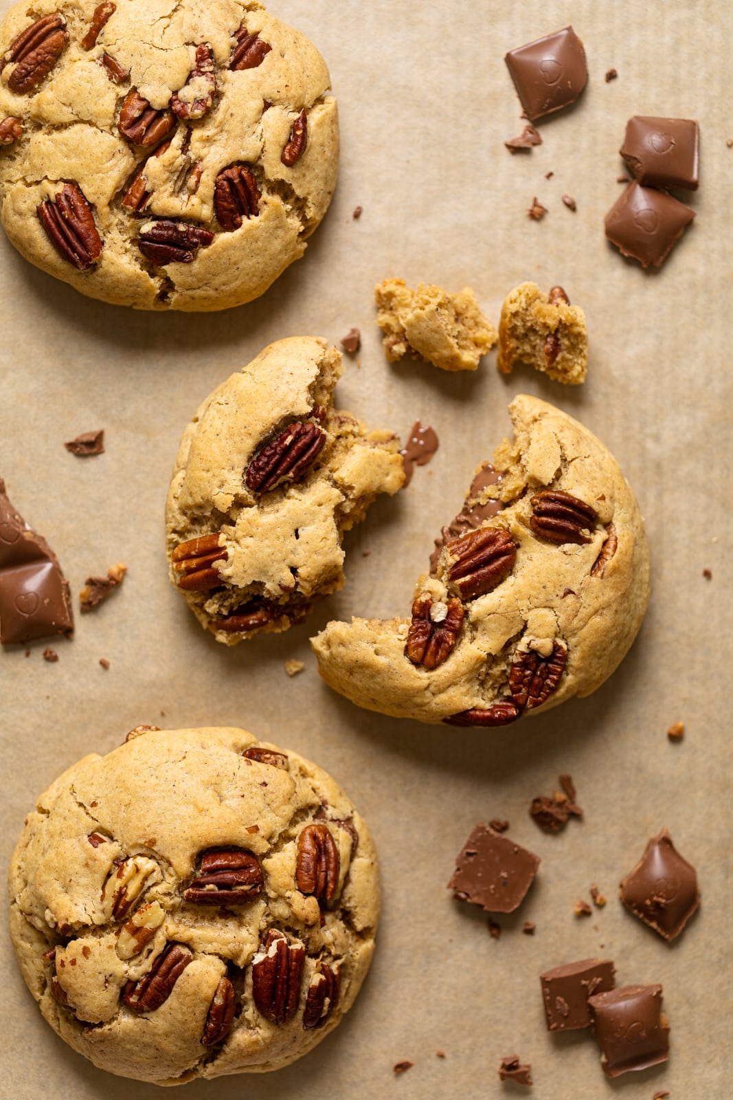 Broken Chocolate Stuffed Butter Pecan Cookie on parchment paper