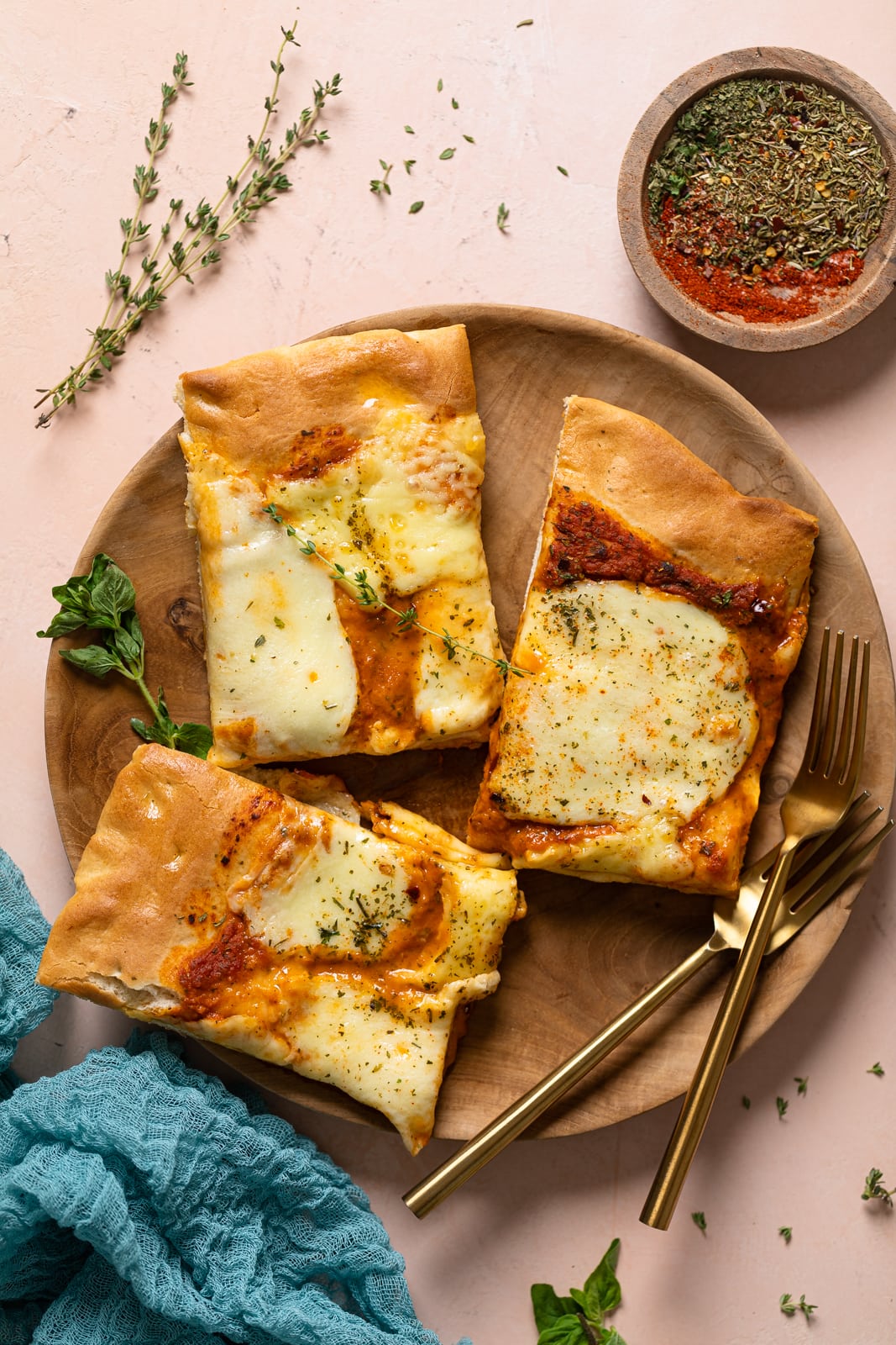 Three pieces of Cheese Sheet Pan Pizza on a plate