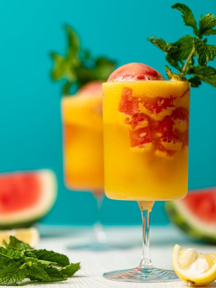 Two colorful Jamaican Me Happy Mocktails against a blue background