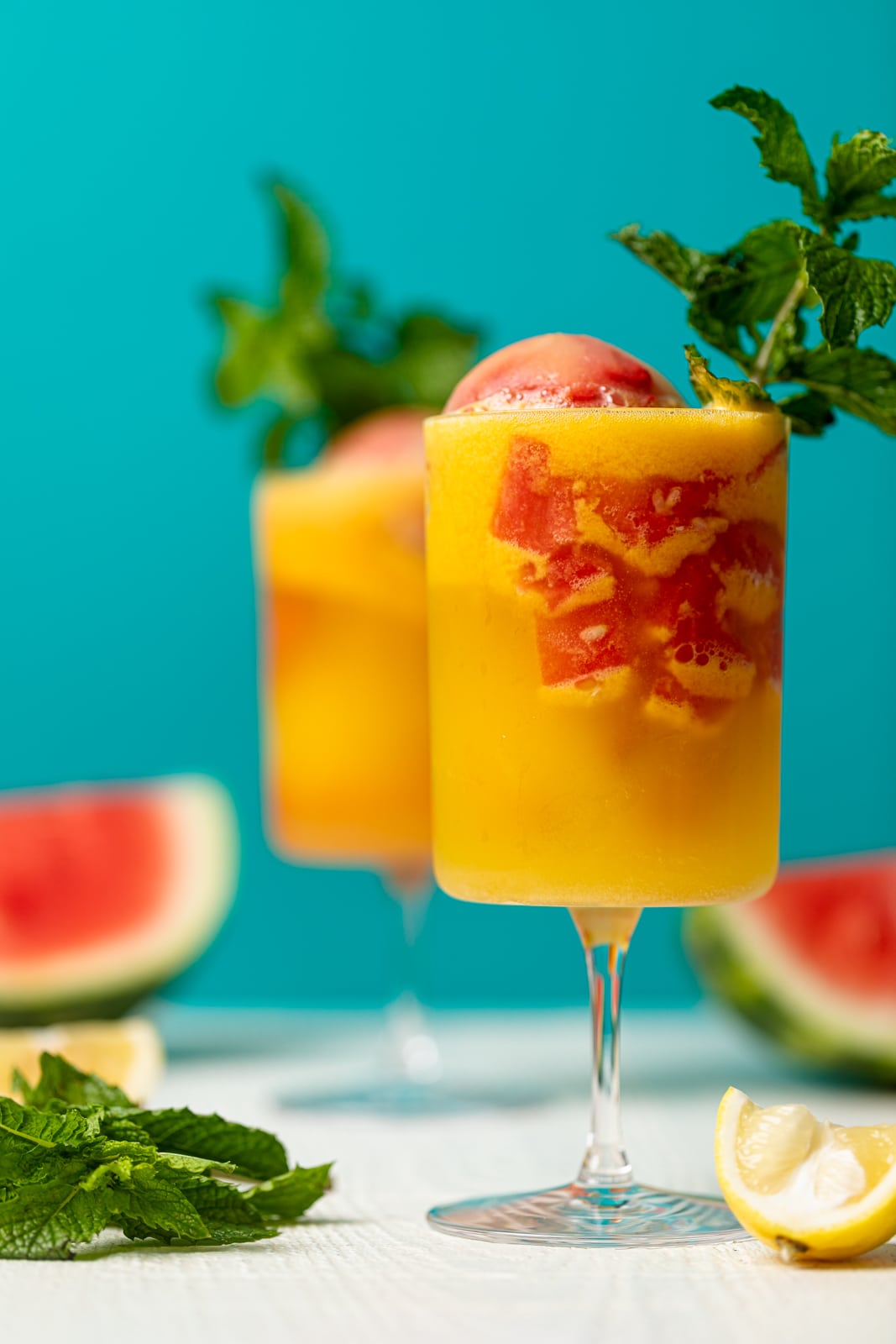 Two colorful Jamaican Me Happy Mocktails against a blue background