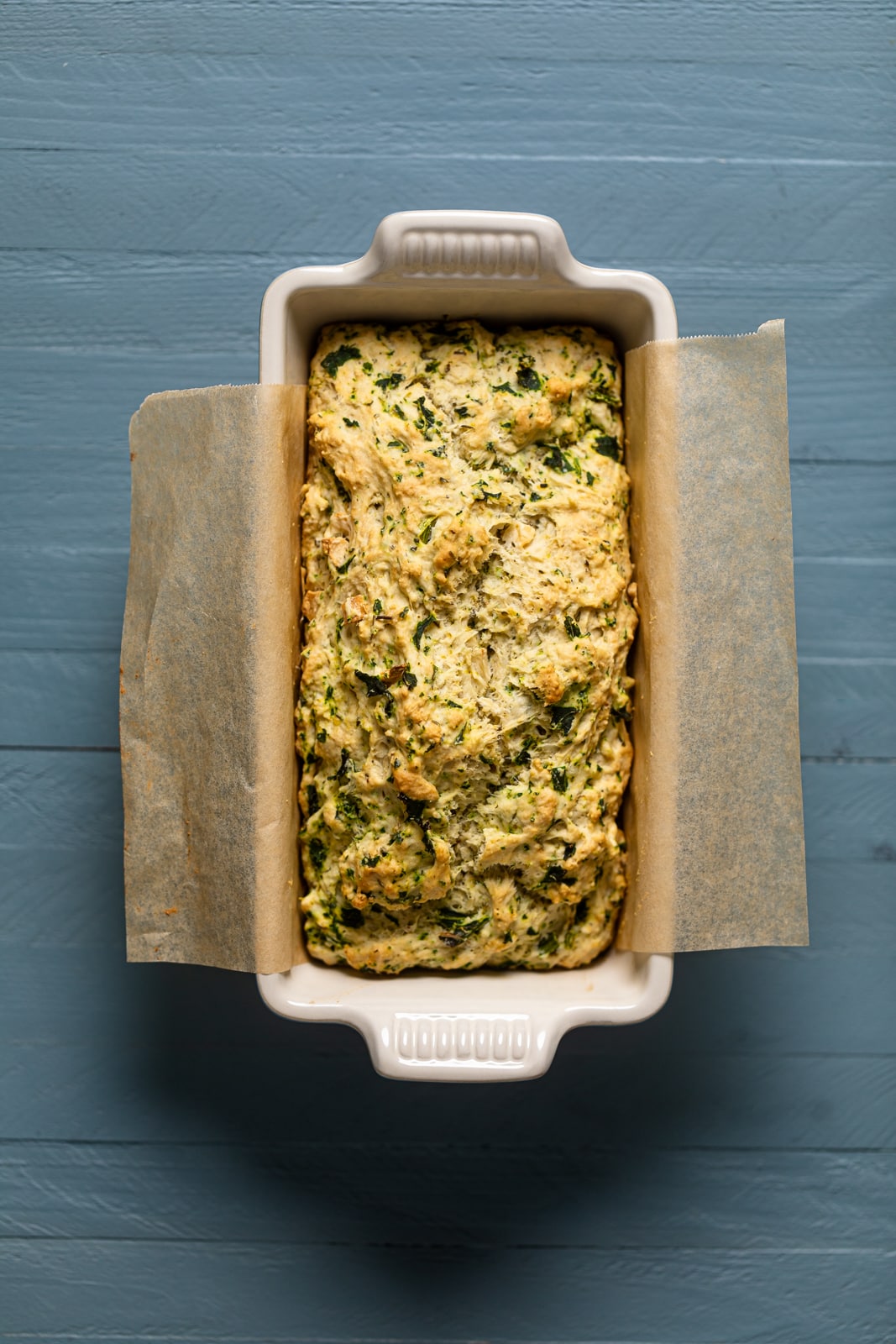 Loaf of Vegan Garlic Herb Kale Bread in a bread pan