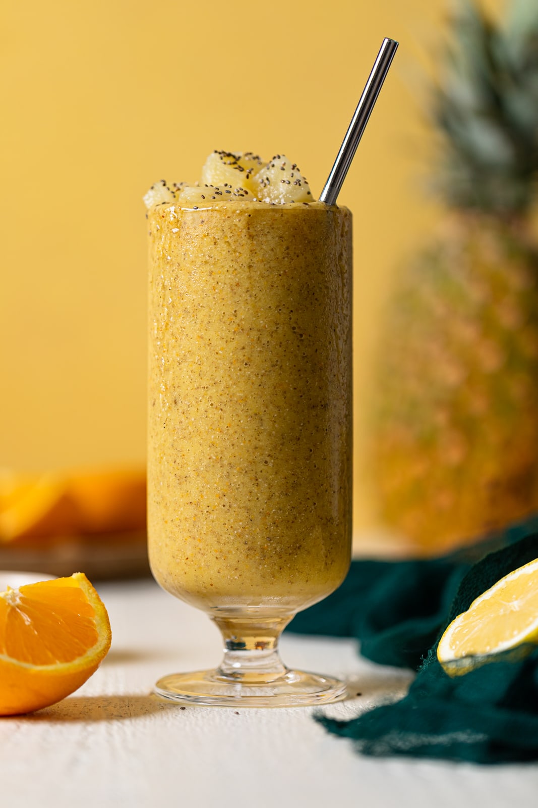 Glass of Pineapple Citrus Smoothie with a straw