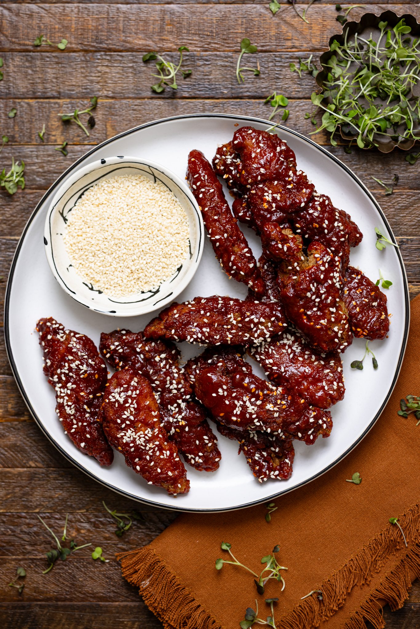 Delicious Gochujang Chicken Tenders on a plate woth sesame seeds.