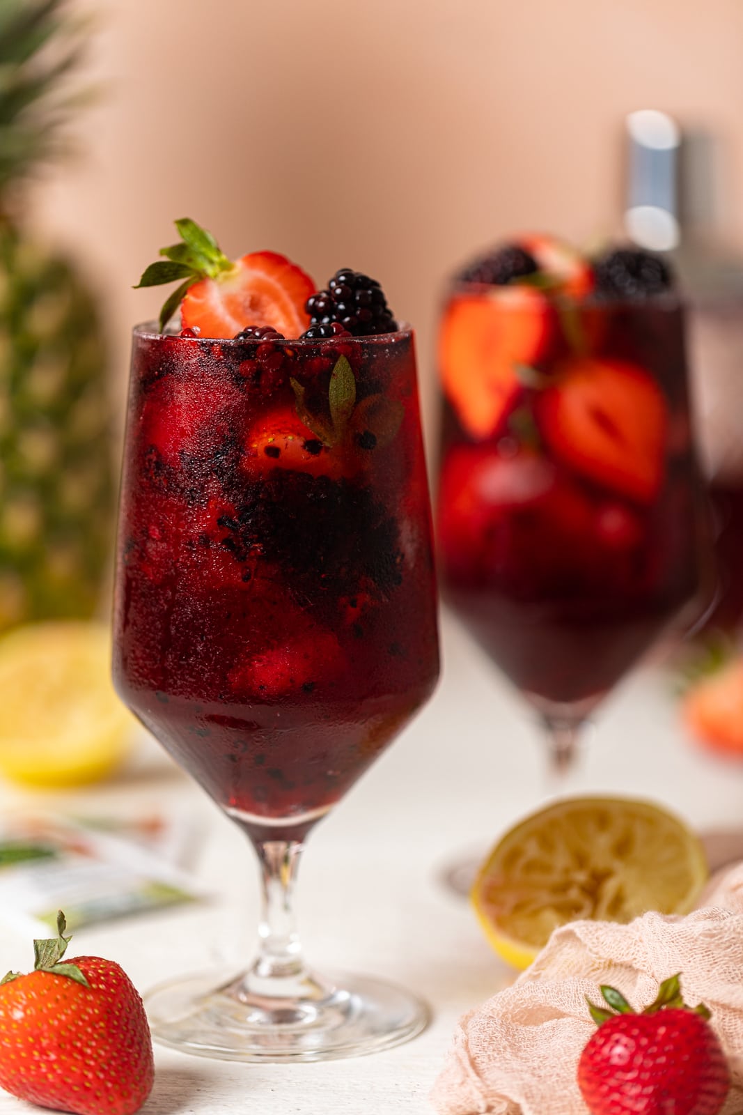 Glass full of fruit and dark red Loaded Hibiscus Mocktail