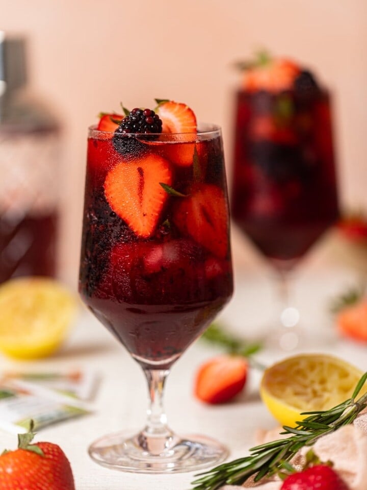 Glass full of dark red Loaded Hibiscus Mocktail