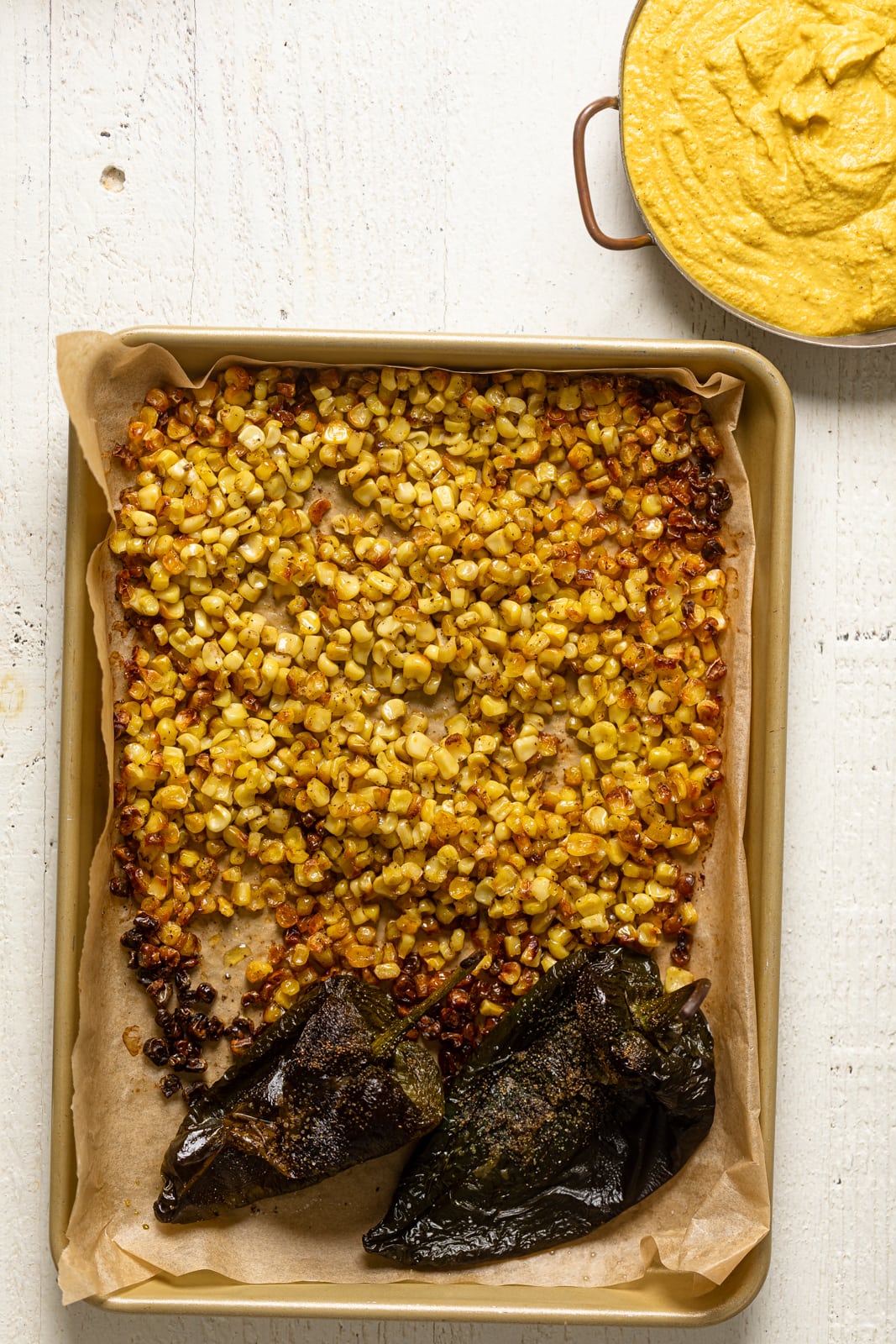 Roasted corn and peppers on a baking sheet