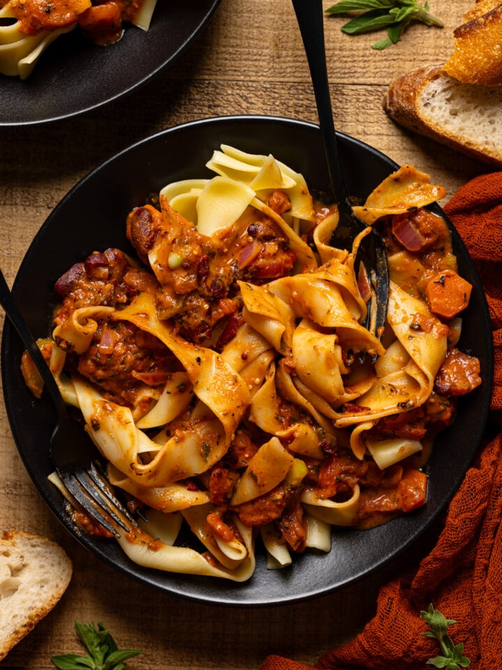 Up close shot of pasta on a black plate.