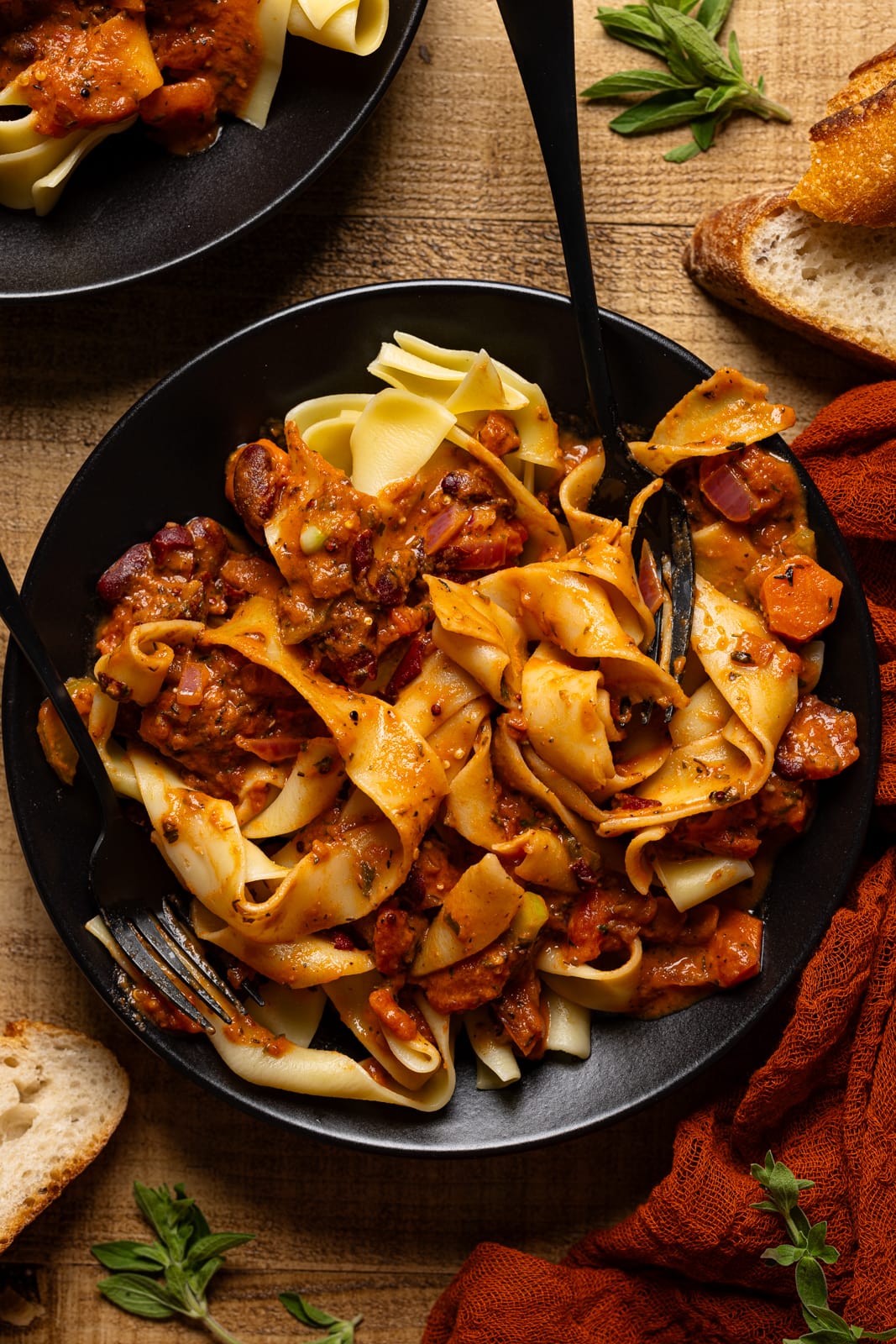 Up close shot of pasta on a black plate.