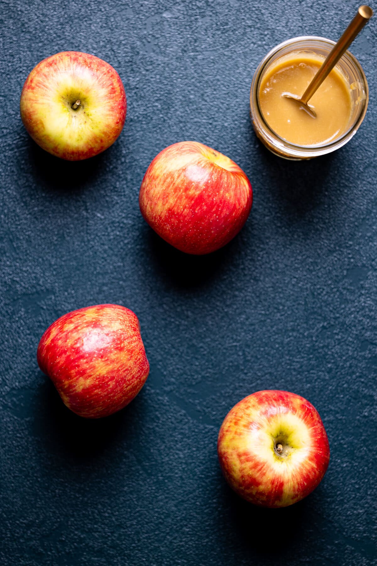 Jar of caramel near apples