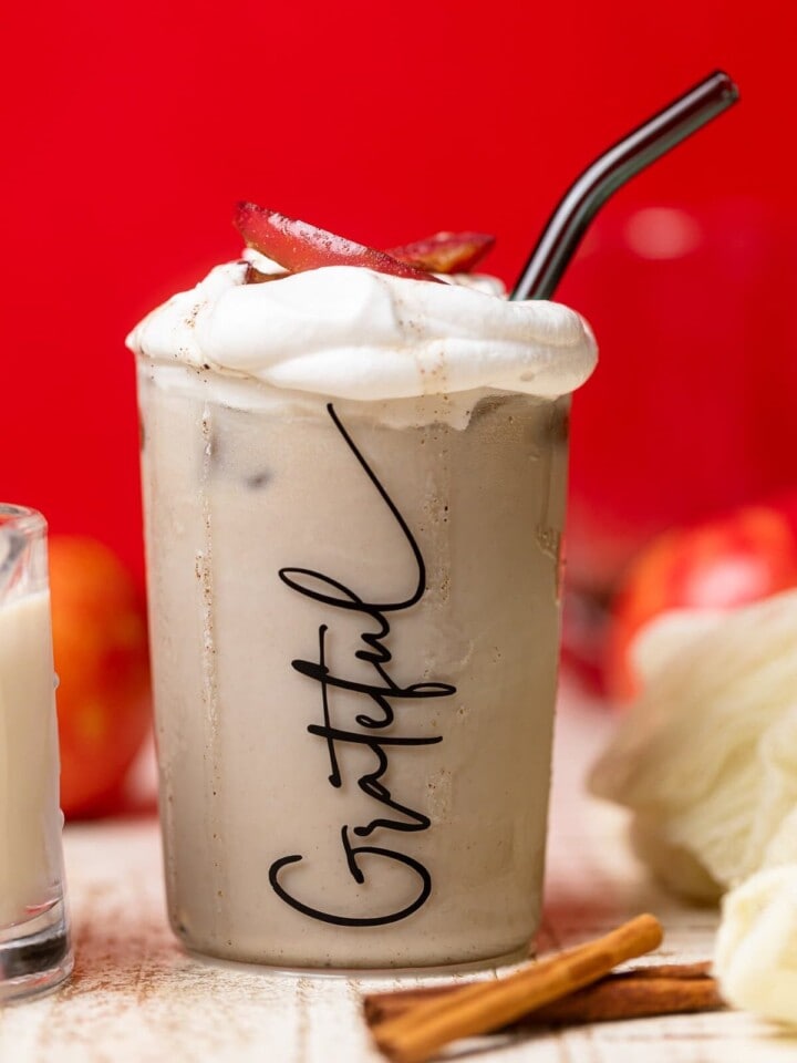 Apple Crisp Oatmilk Latte in a glass that has "Grateful" written on it