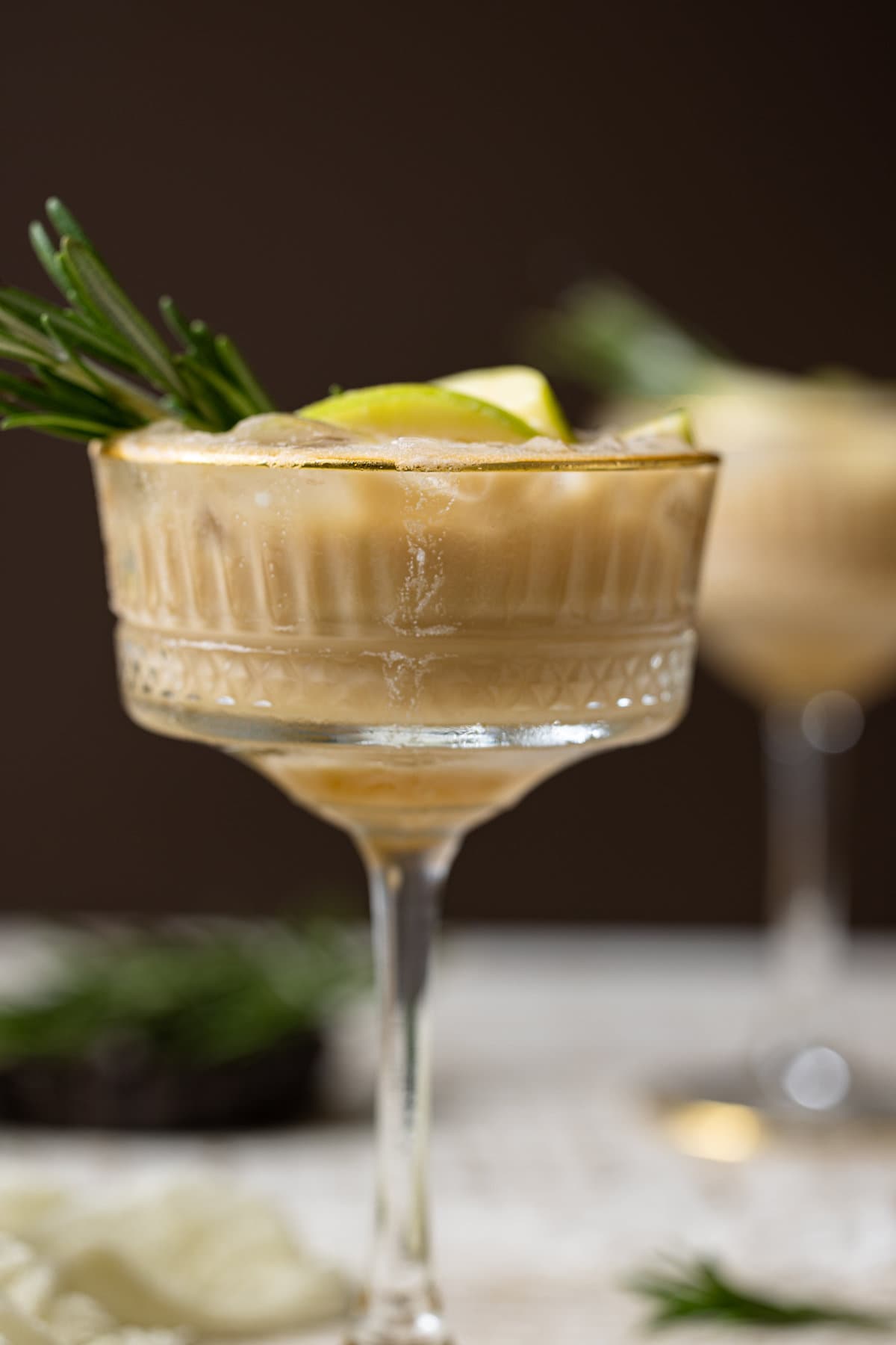 Closeup of an Apple Caramel Espresso Martini in a long-stemmed glass