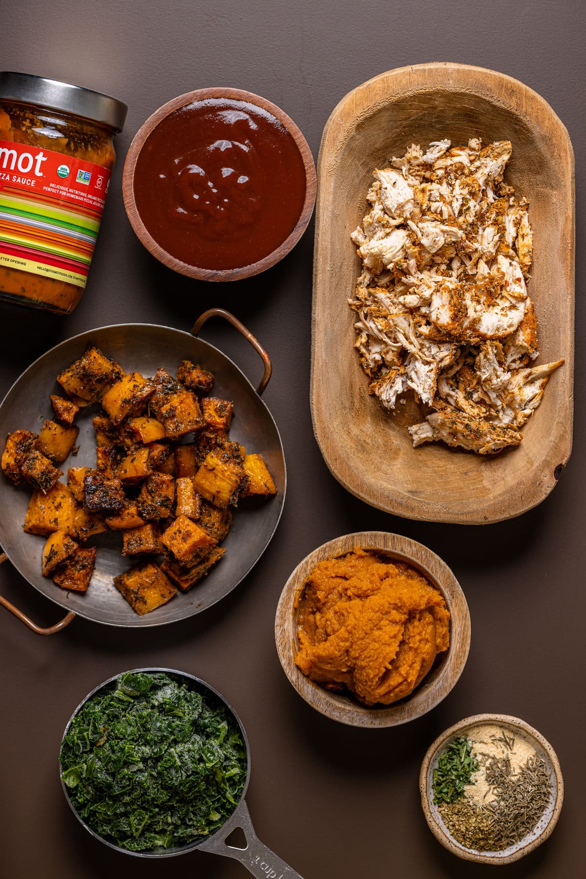 Ingredients for Pumpkin BBQ Chicken Pizza with Butternut Squash including pizza sauce, seasonings, and pumpkin puree 