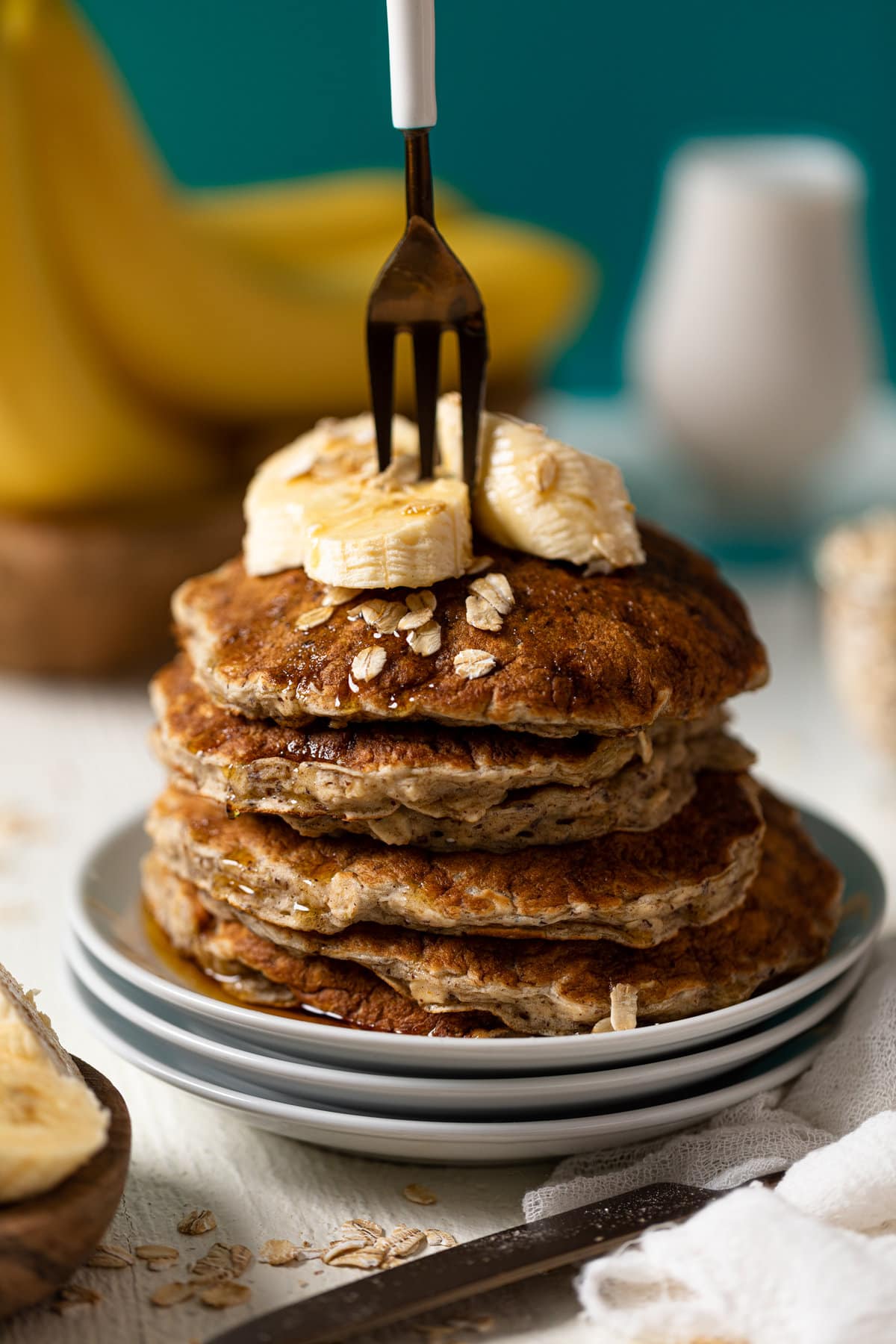 Fork piercing a stack of Fluffy Banana Oat Pancakes