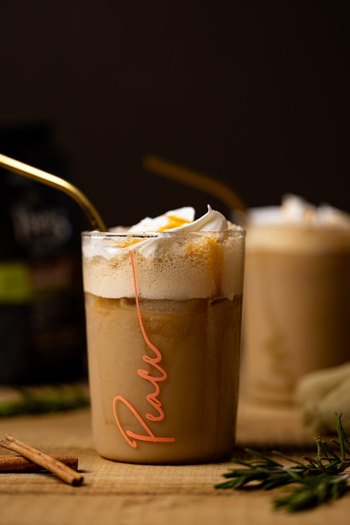 Closeup of an Iced Brown Sugar Shaken Espresso in a glass with \"Peace\" written on it