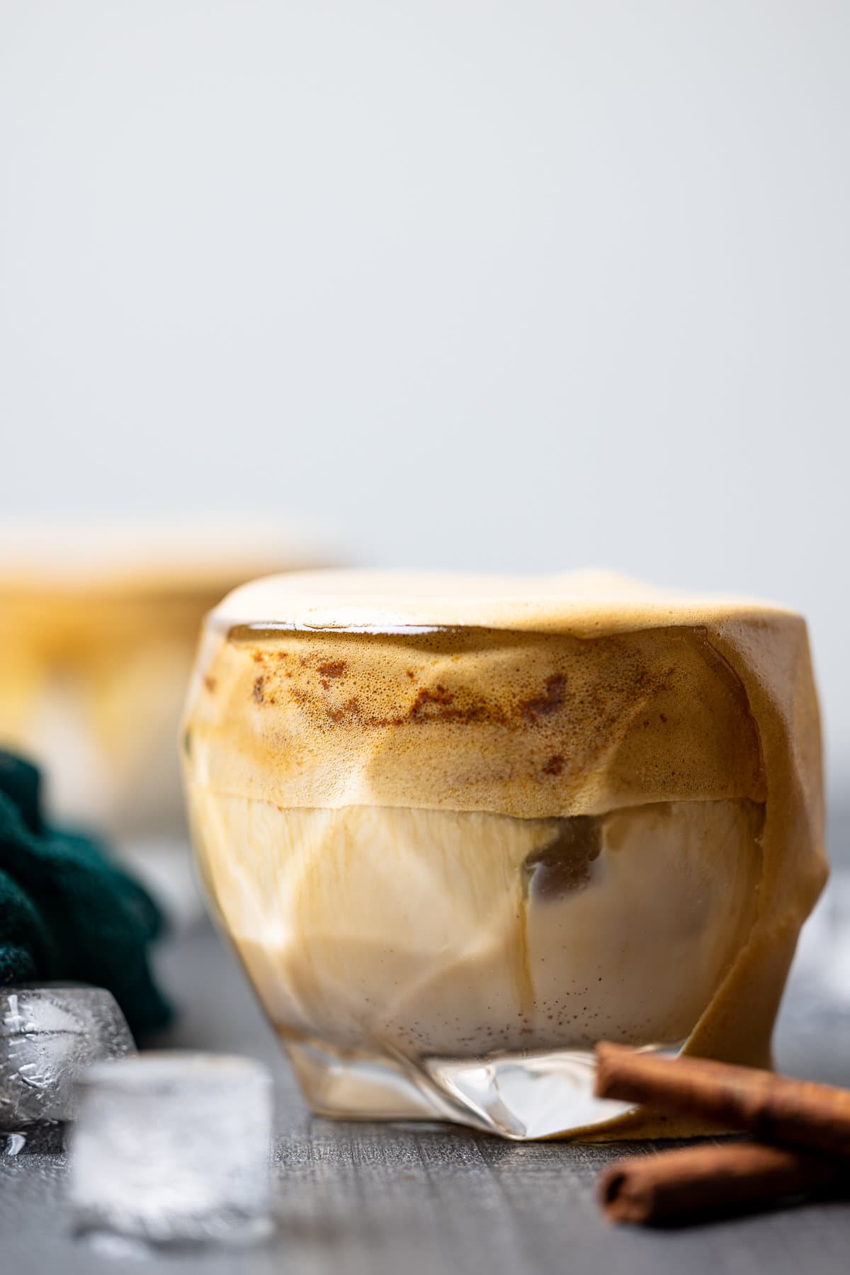 Overflowing glass of Iced Dalgona Coffee Vanilla Latte