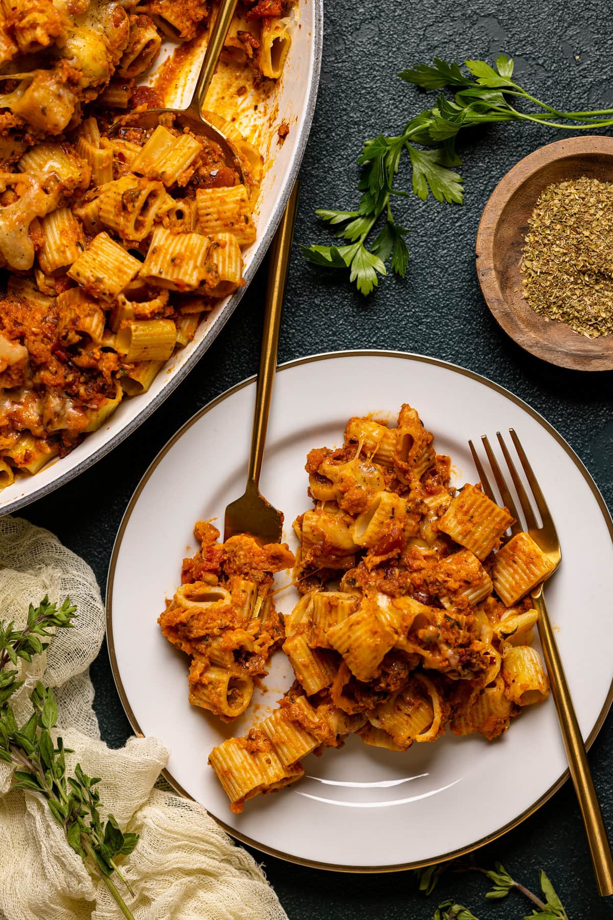 Overhead shot of a plate of Spicy Pumpkin Pasta Bake with two forks