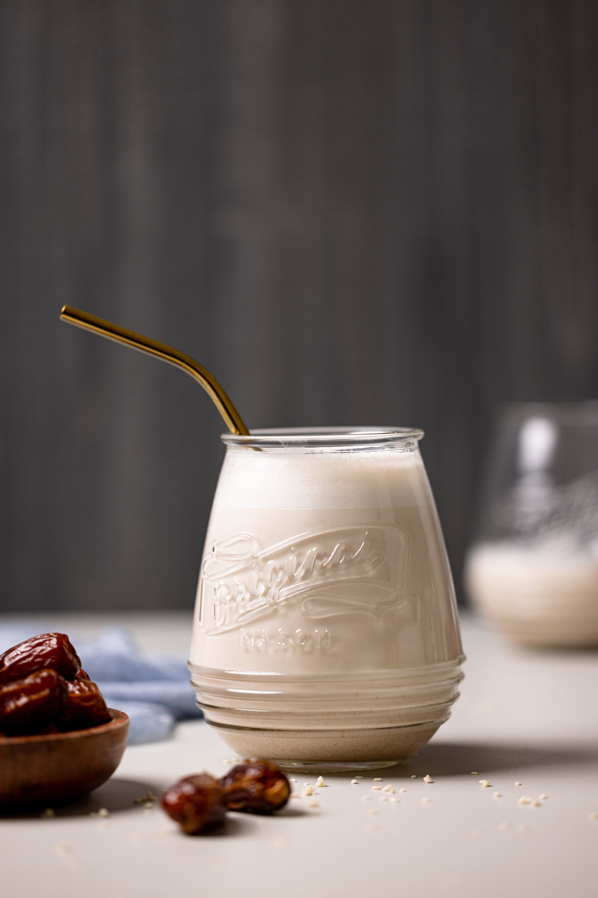 Glass of Creamy Vanilla Sesame Milk with a straw