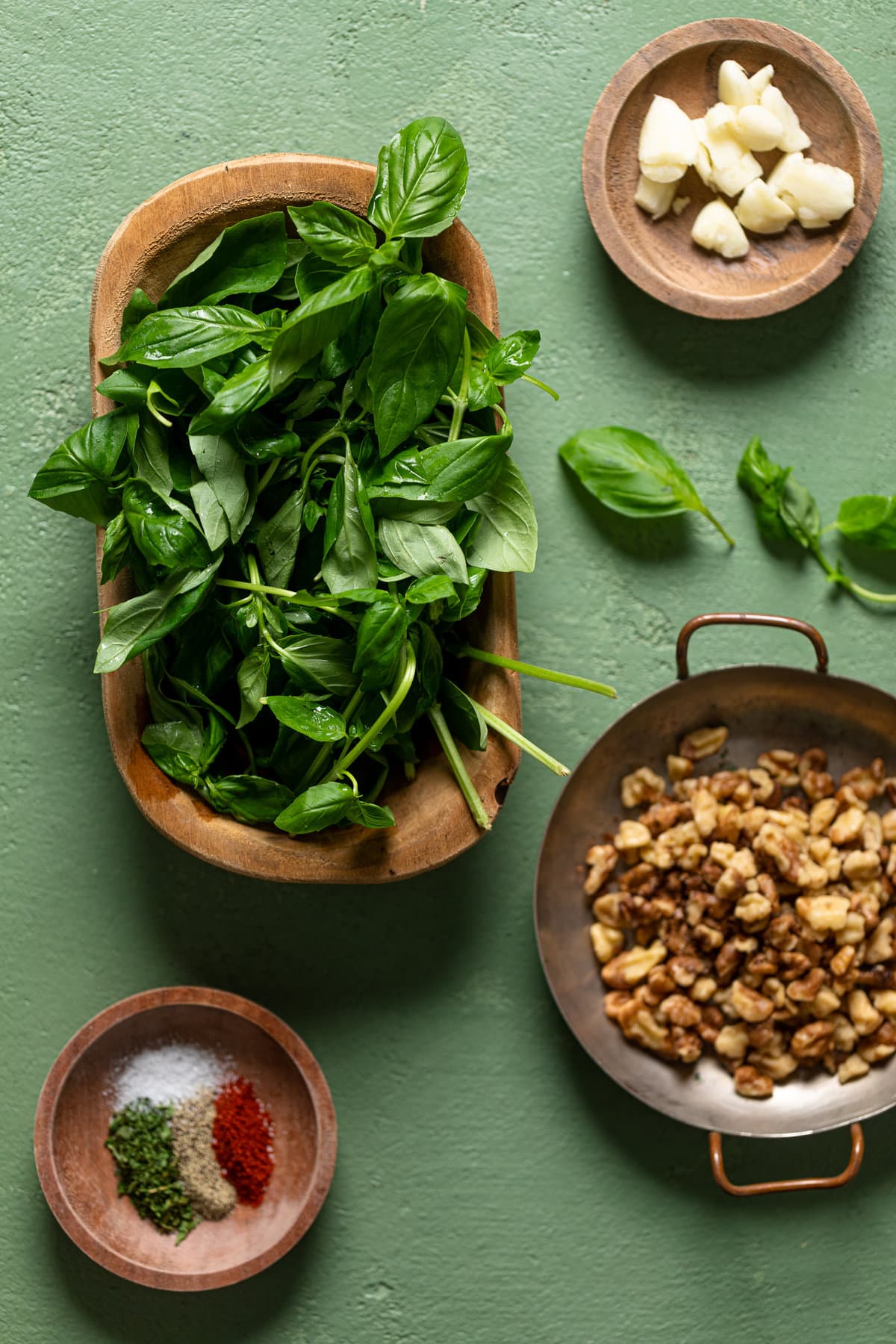 Ingredients for Creamy Shrimp Pesto Tortellini Pasta including spinach, garlic, and seasonings