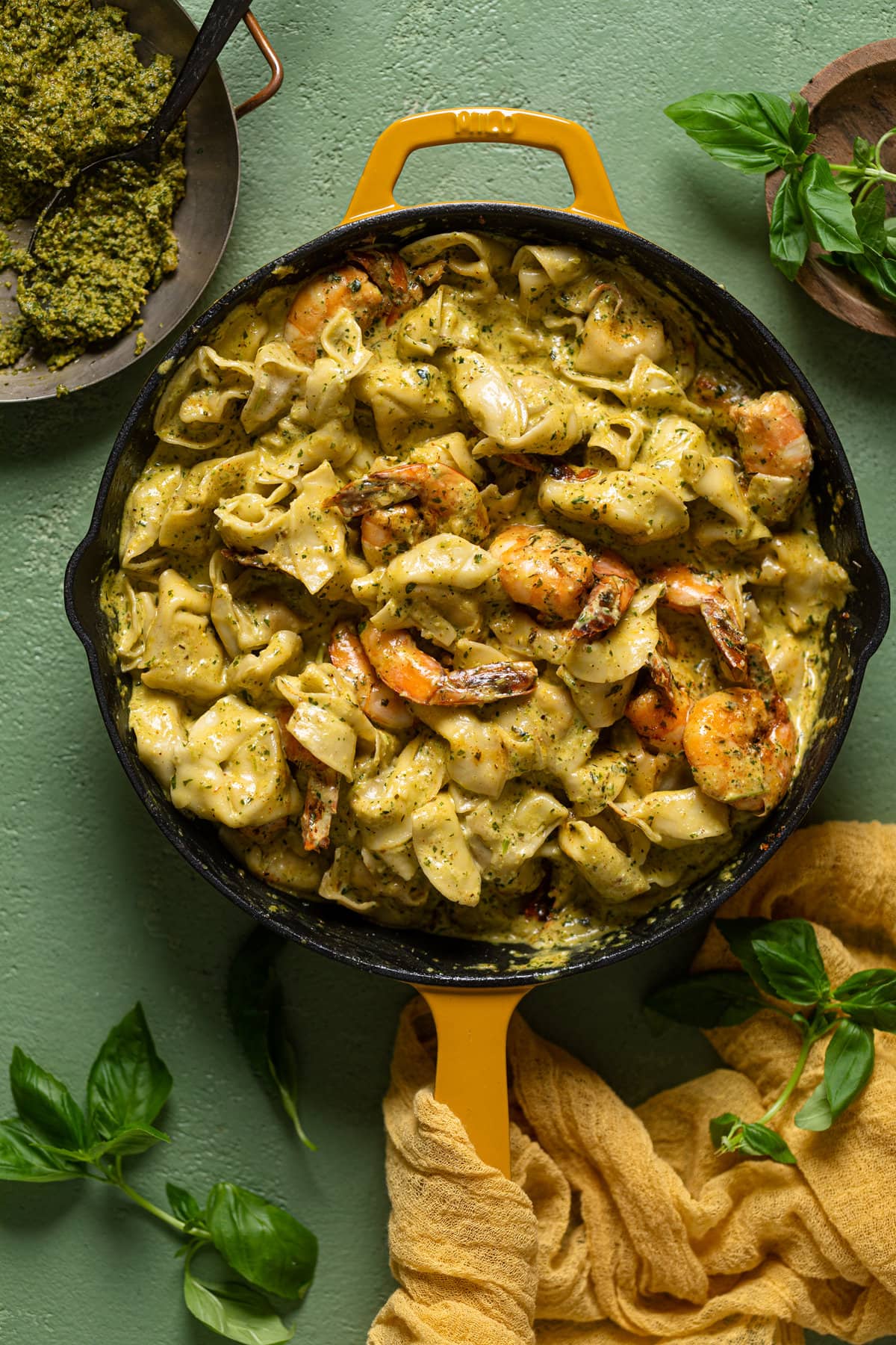 Overhead shot of a skillet of Creamy Shrimp Pesto Tortellini Pasta