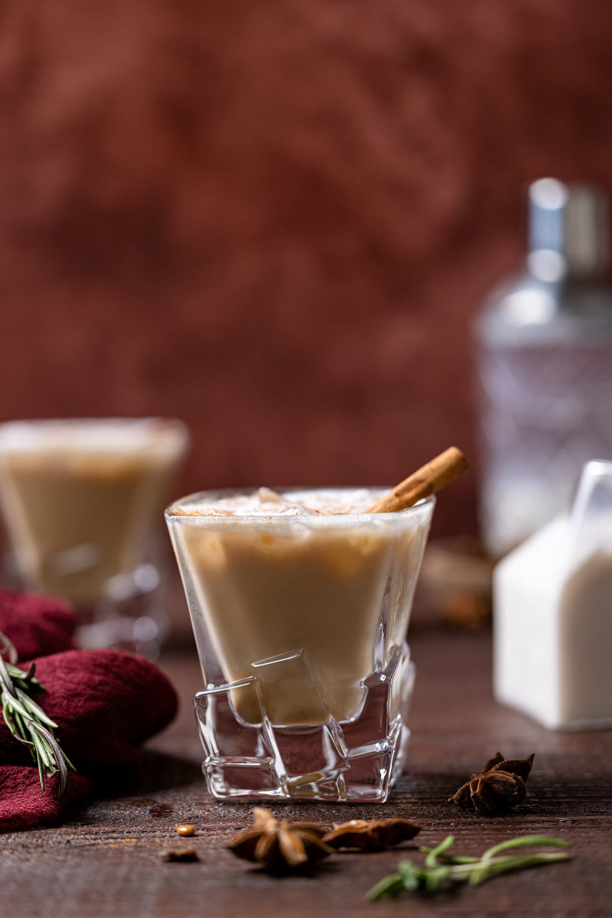 White Russian Mocktail with a cinnamon stick in decorative glassware