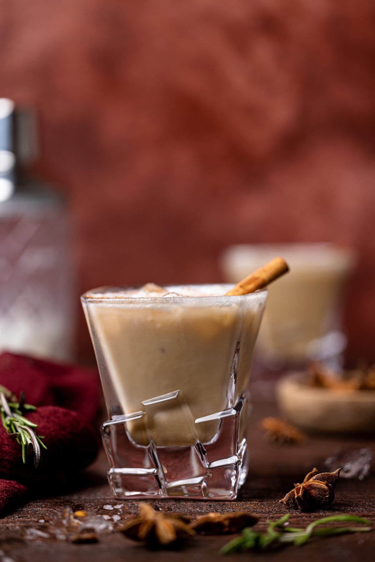 White Russian Mocktail in decorative glassware against a red background