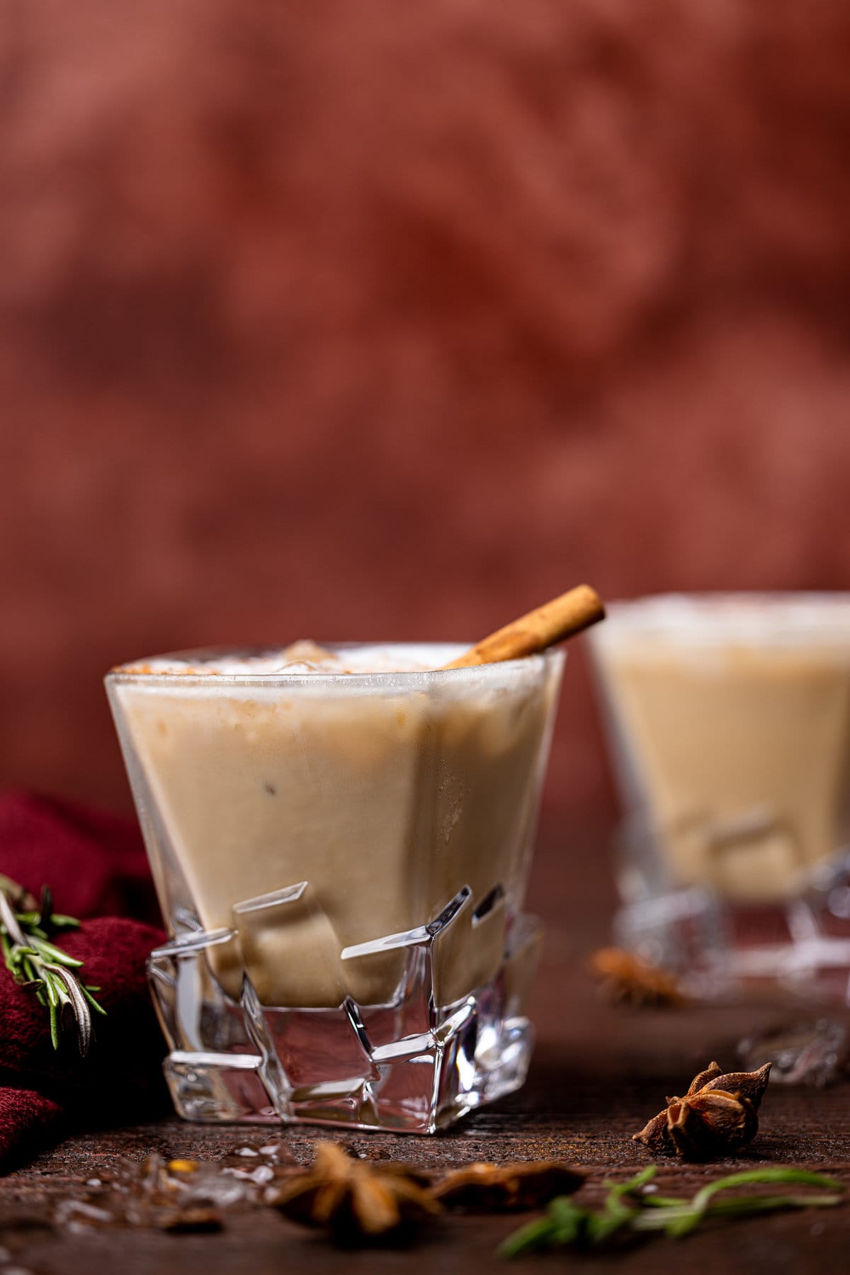 White Russian Mocktail in decorative glassware against a red background