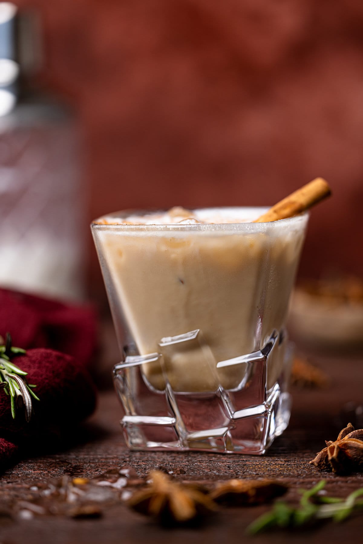 White Russian Mocktail with a cinnamon stick in decorative glassware