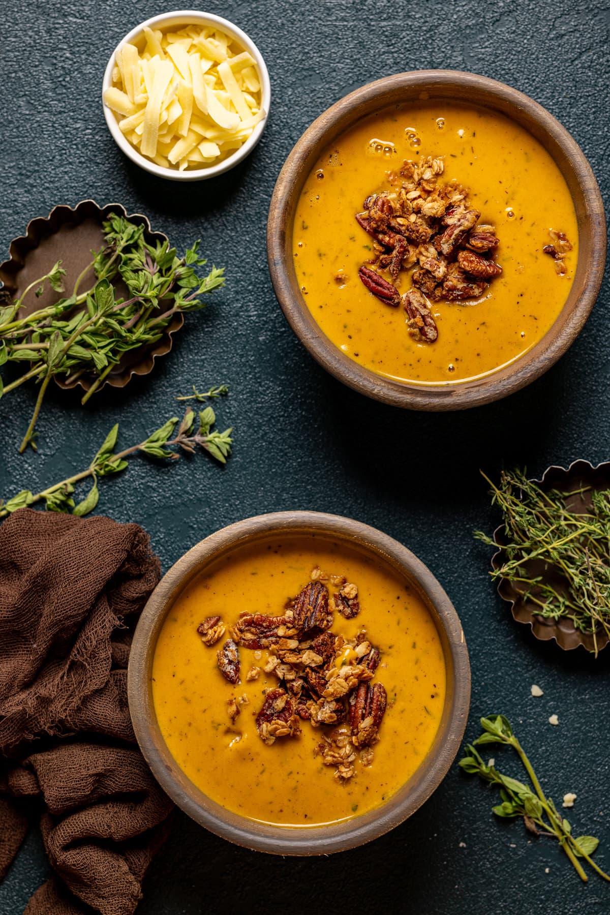 Overhead shot of two bowls of Apple Cheddar Sweet Potato Soup