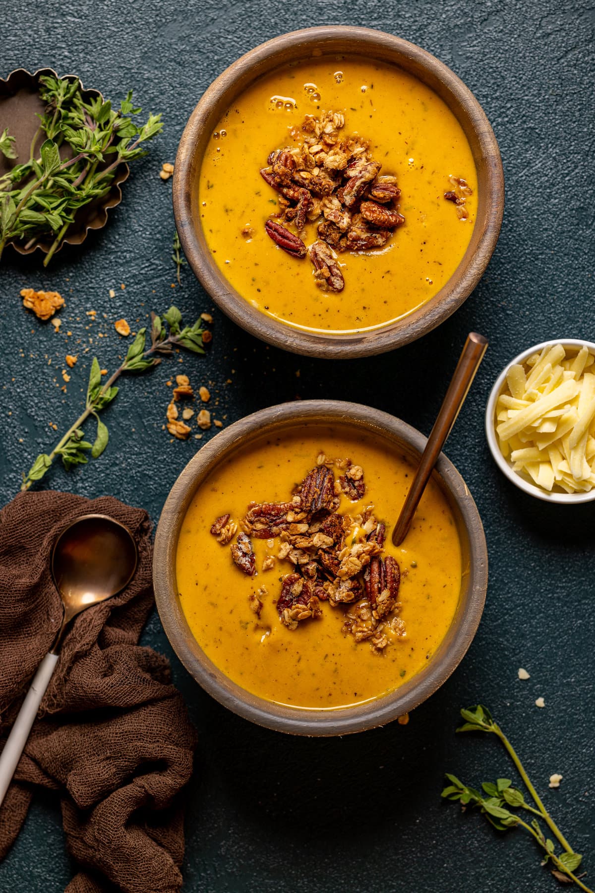 Overhead shot of two bowls of Apple Cheddar Sweet Potato Soup