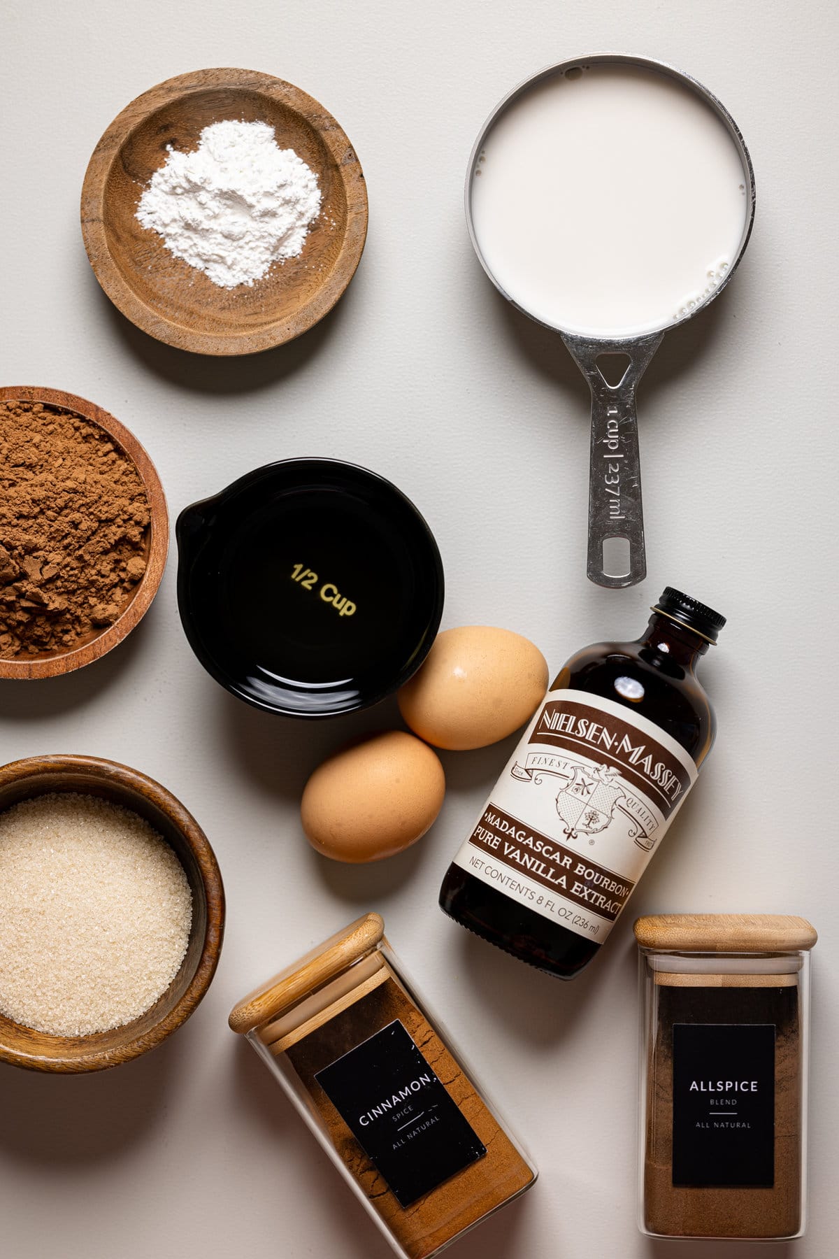 Ingredients for Chocolate Sweet Potato Cupcakes including eggs, vanilla extract, and allspice