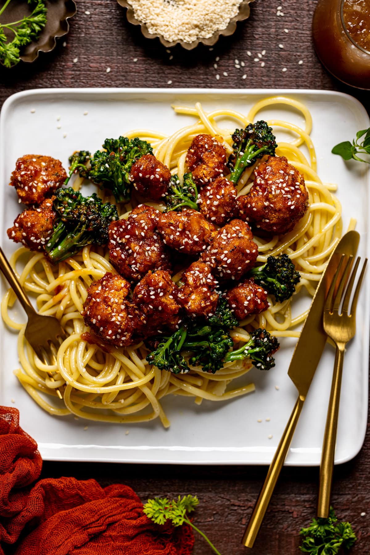 Plate of Plant-based Sesame ‘Chicken\' with Noodles and silverware