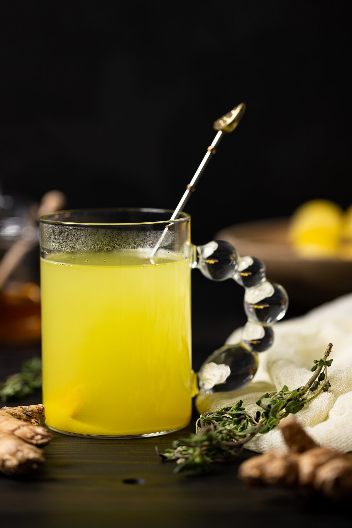 Closeup of a glass of Citrus Ginger Turmeric Ice Cubes with Tea