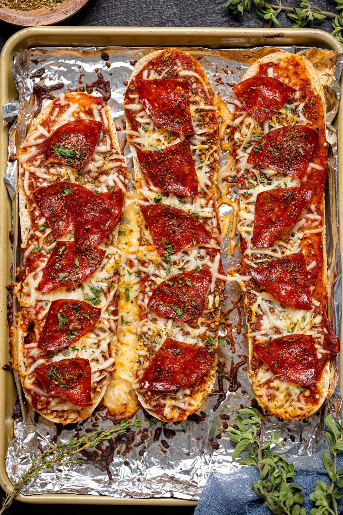 Closeup of French Bread Pepperoni Pizzas on a baking sheet