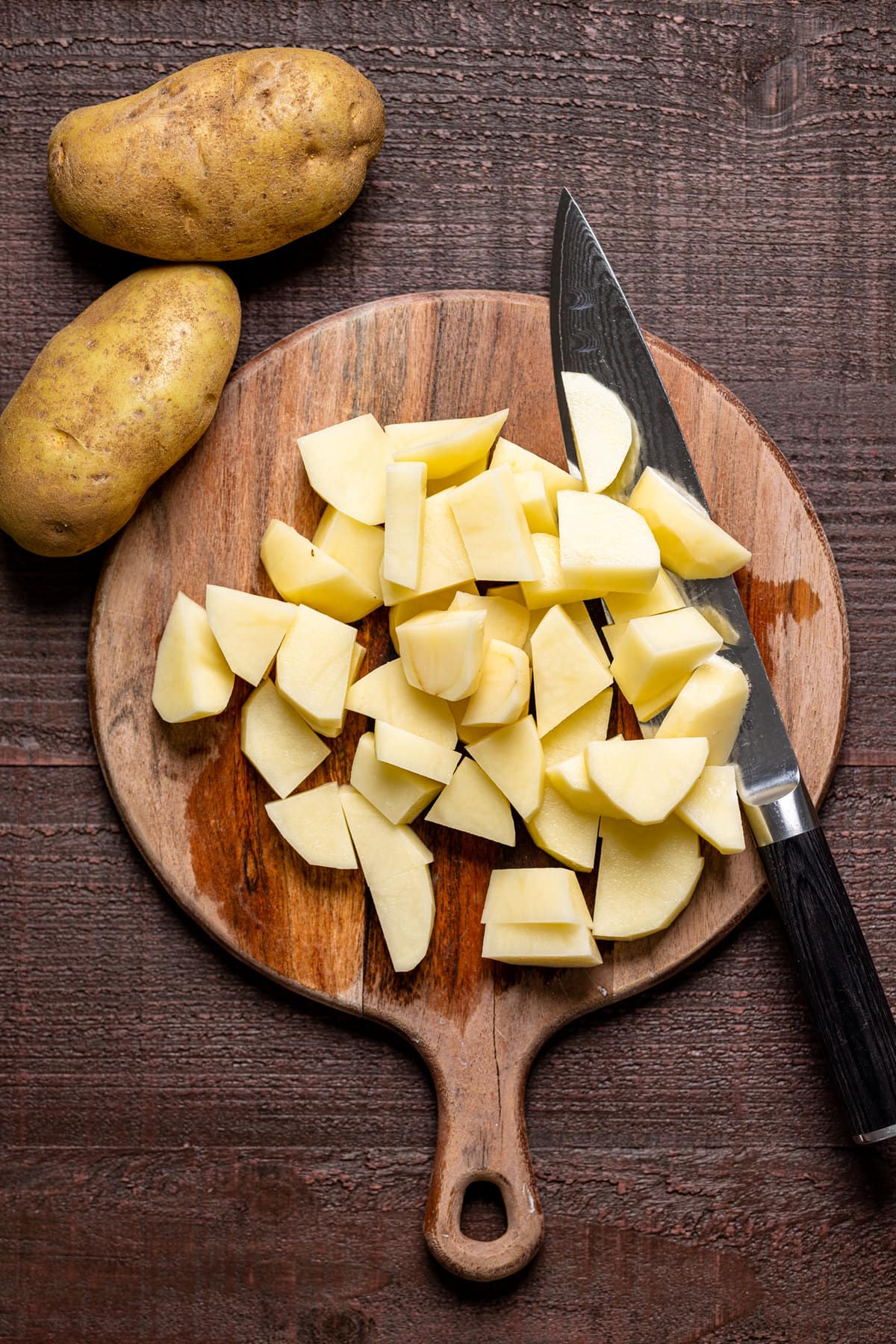 Diced potato on a cutting board with a knife