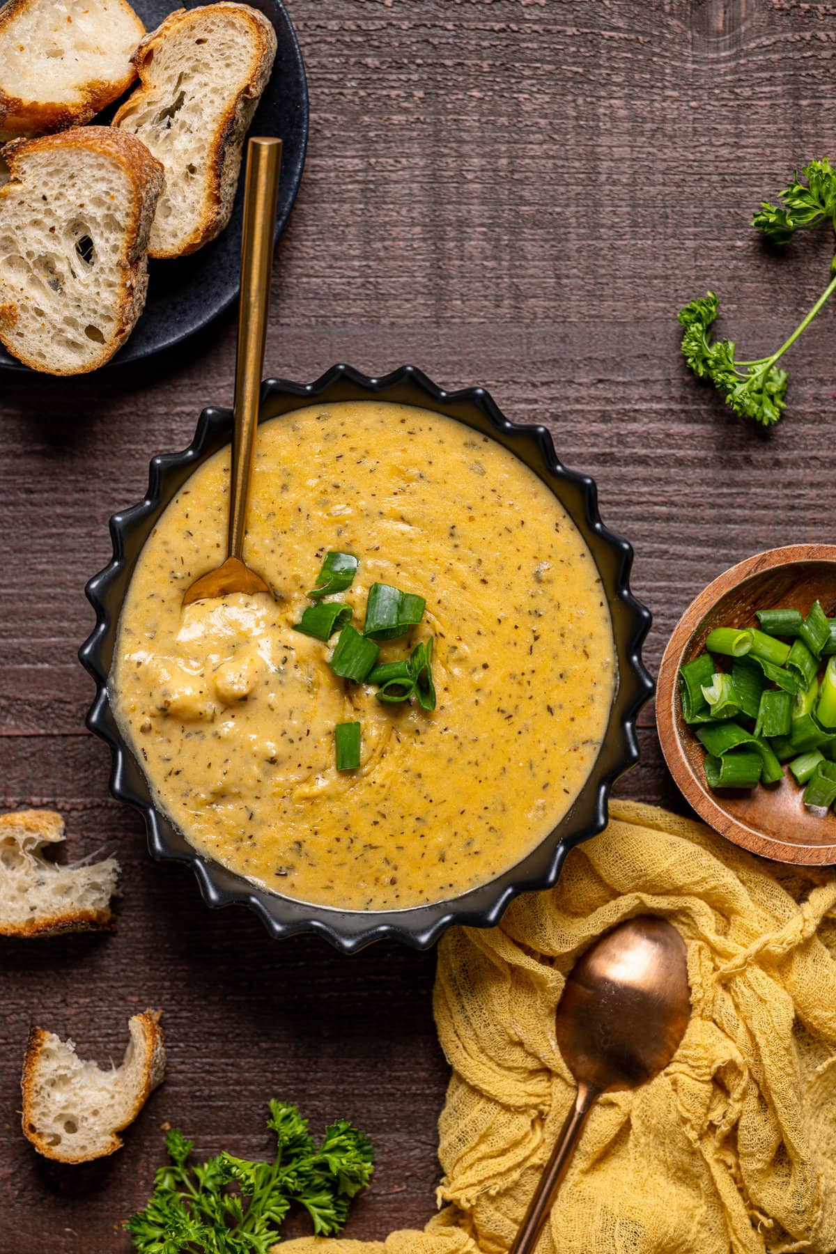 Bowl of Hearty Cheddar Garlic Herb Potato Soup with a spoon