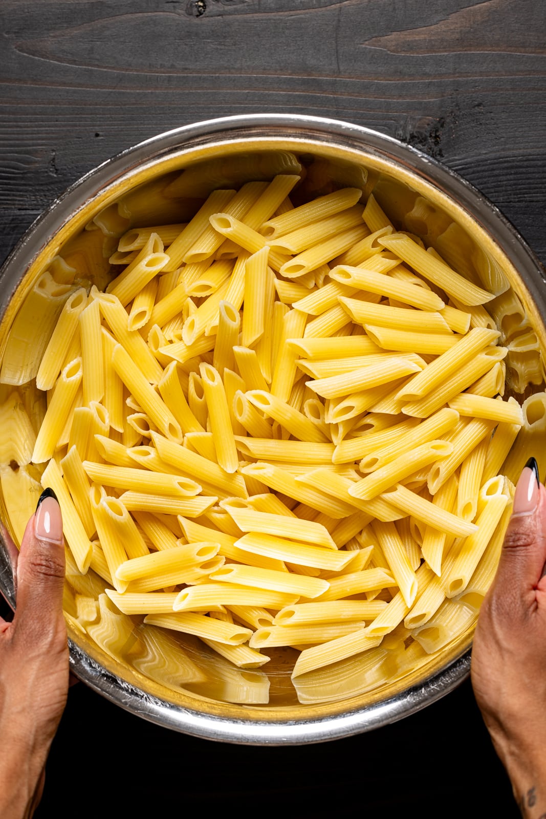 Cooked penne pasta in a coriander.