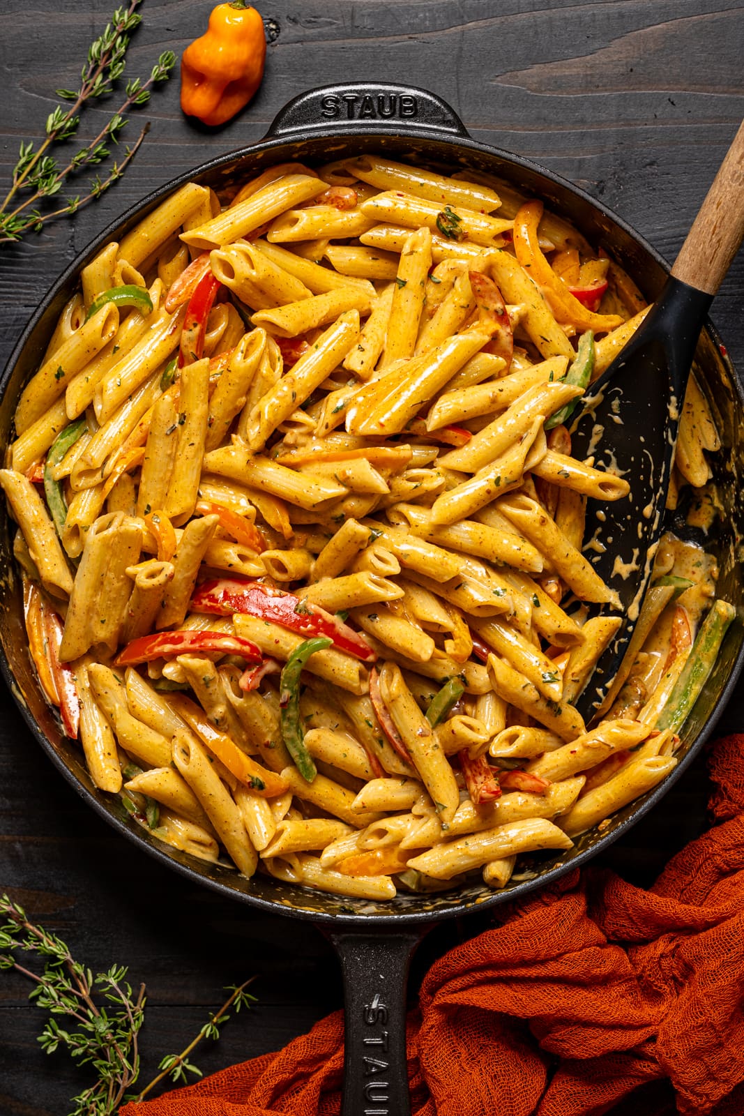 Rasta pasta in a black skillet with spoon.