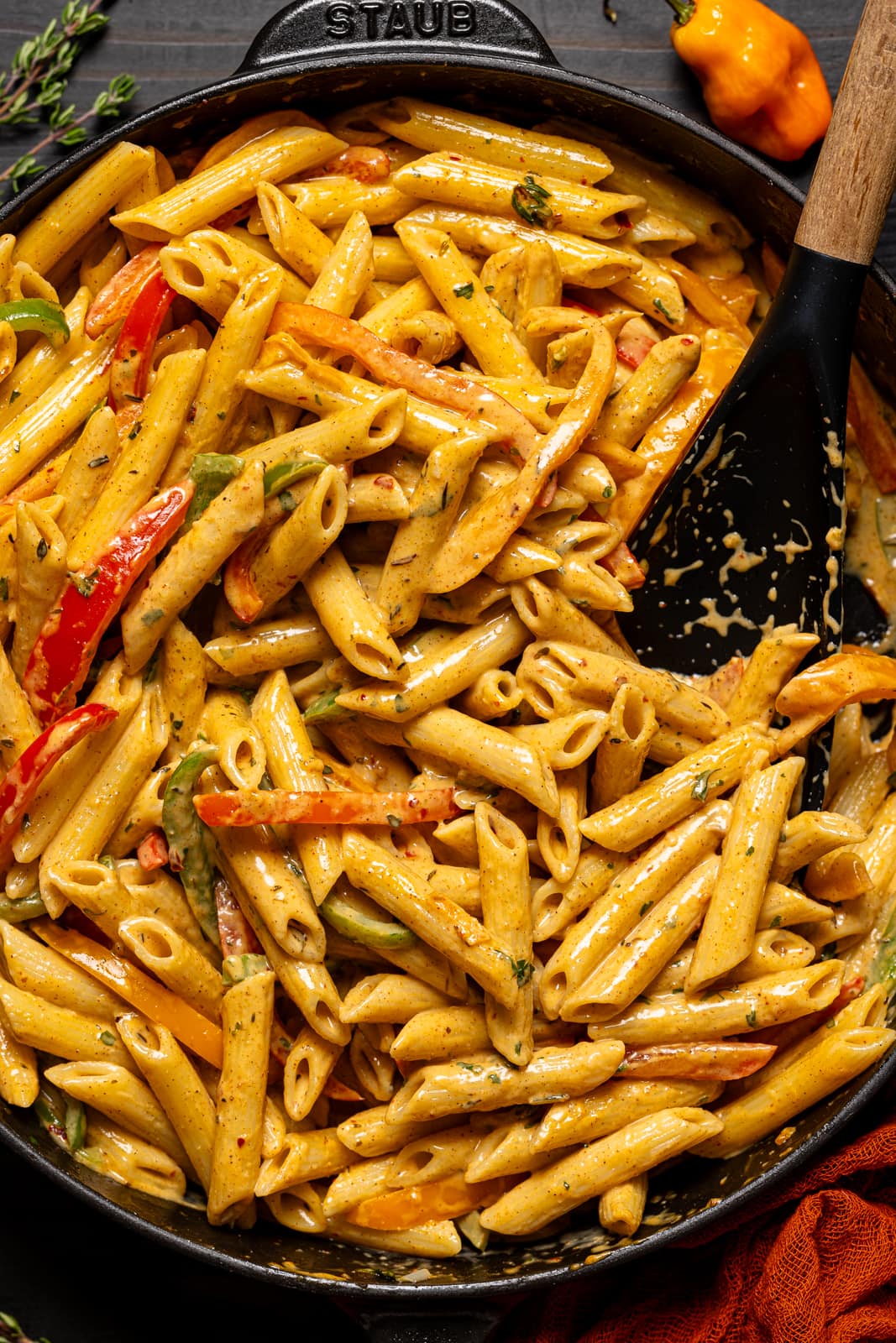 Creamy rasta pasta in a black skillet with a spoon. 