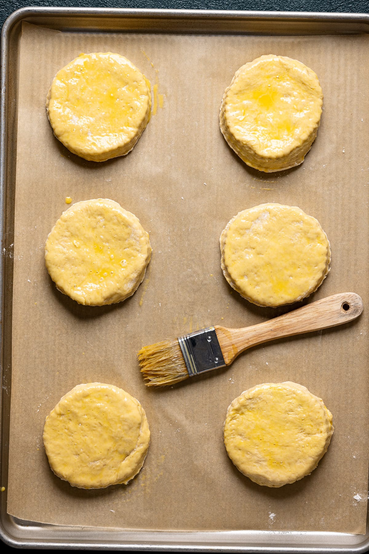 Flaky Sweet Potato Biscuit dough rounds topped with an egg wash