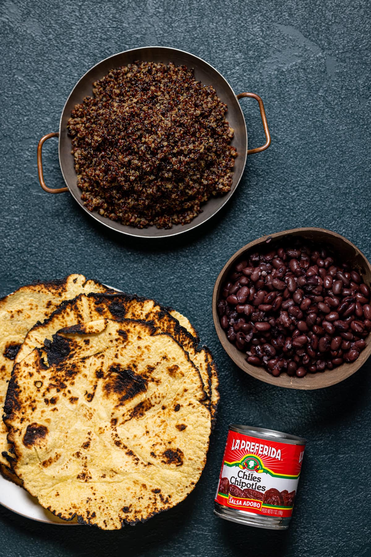 Ingredients for Chipotle Sweet Potato Quinoa Tacos including black beans, tortillas, and chipotle chilis