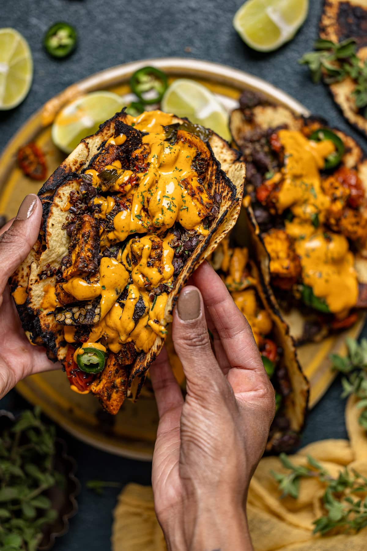 Hands holding a Chipotle Sweet Potato Quinoa Taco