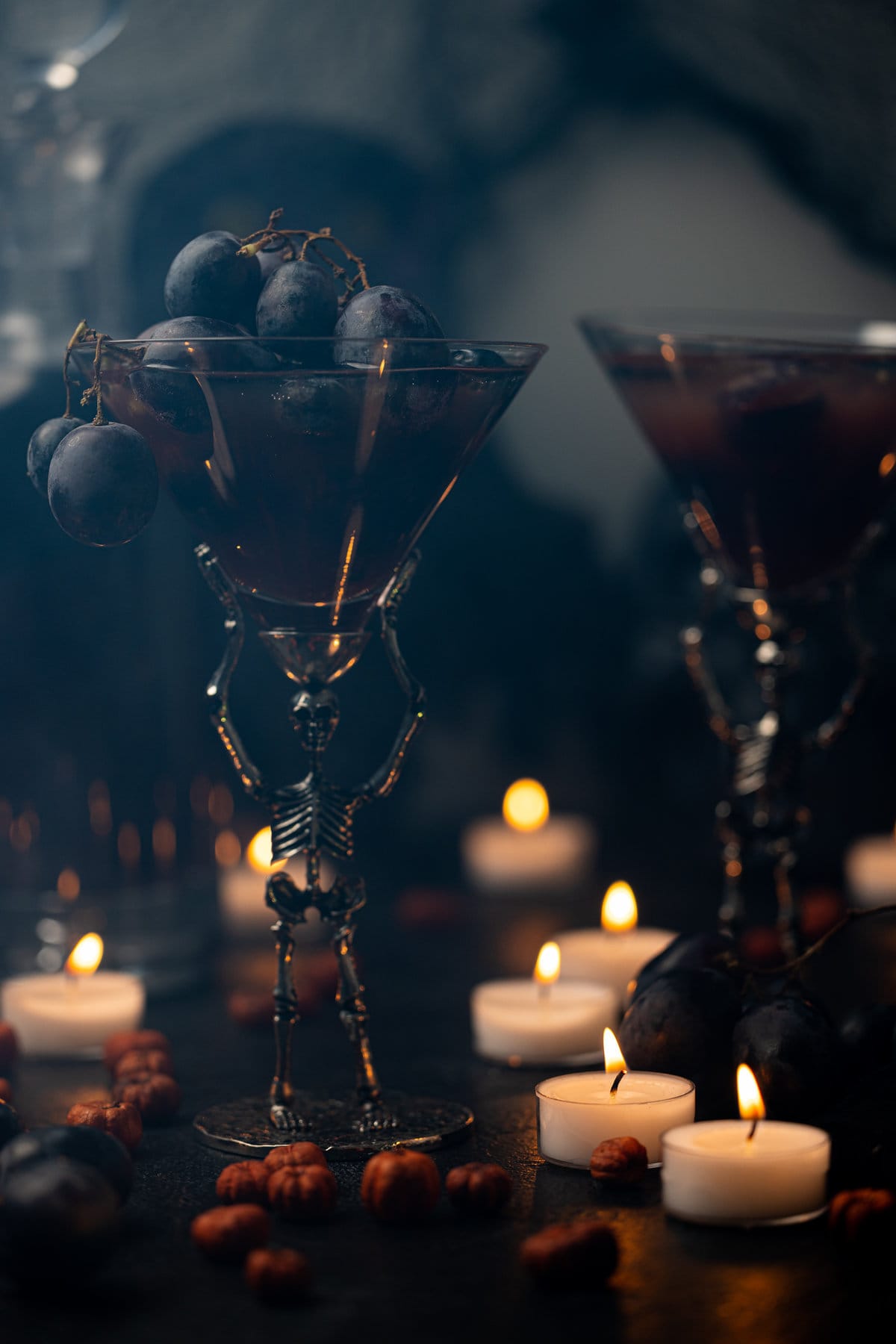 Halloween Witches Brew Mocktail in skeleton glassware overflowing with black grapes