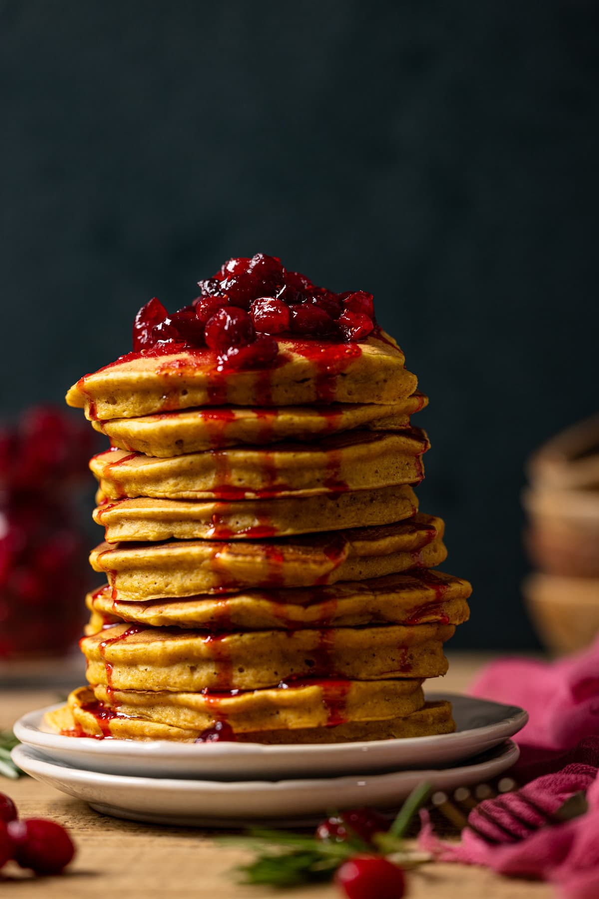 Large stack of Apple Cider Pumpkin Pancakes topped with Cranberries